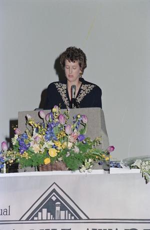Primary view of object titled '[Cece Cox standing at podium]'.