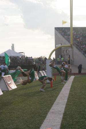 [NT Cheer performing flips during the UNT v Navy game]