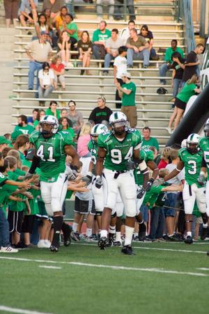 [Players high-fiving kids at UNT vs. Navy game, 2007]