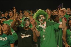 [Students in crowd at UNT v ULM game]