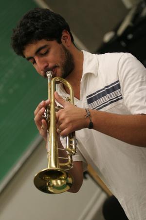 [Student practicing trumpet in class]