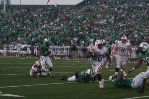 [FAU player dodging UNT players, September 22, 2007]