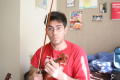 Photograph: [Student holding violin and bow]