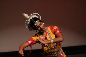 [Student leaning in pose on stage at ISA Diwali event]