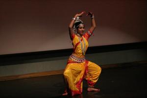 [Student in pose on stage at ISA Diwali event]