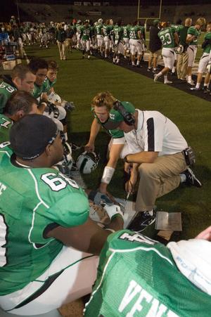 [Coach and players planning at homecoming, 2007]