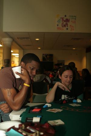 [Two students at a table for UNT's Casino Night]