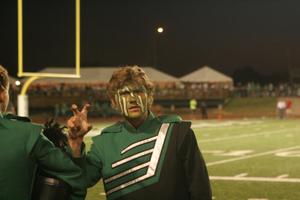 [Band member with face-paint at UNT v ULM game]