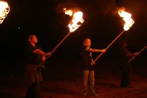 [Talons members with bonfire torches]
