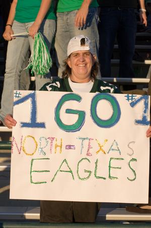 [Visitor holding sign at Homecoming game, 2007]