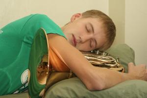 [Student sleeping with French horn]