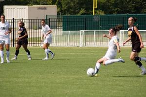 [Kendall Juett moving to kick the soccer ball]