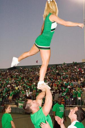 [Cheer team and alumni performing at Homecoming game, 2007]