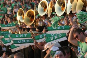 [Mean Green Brigade brass section performing]