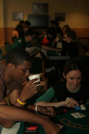[Two students at a game table for UNT's Casino Night]