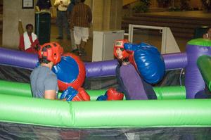 [Students fighting in inflatable boxing ring]
