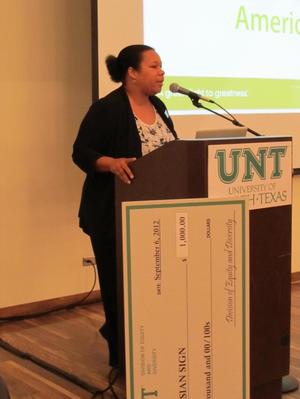 [Cheylon Brown speaking with check at the Fall Welcome]