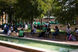 [Students seated around the fountains of the Library Mall]