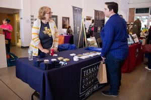 [Photograph of the Texas A&M University Commerce table]