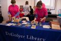Photograph: [Faculty members of the DeGolyer Library setting up table]