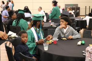[Student and children at 2017 Multicultural Graduation 1]