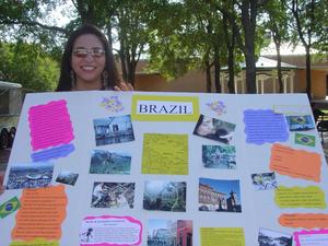 [Student holding Brazil poster]