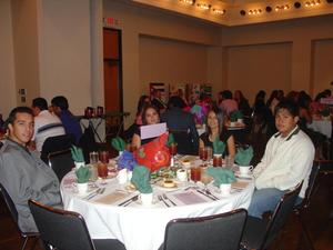 [Guests around Celebración Banquet table]