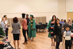[Graduate greeting faculty at 2017 Multicultural Graduation 2]