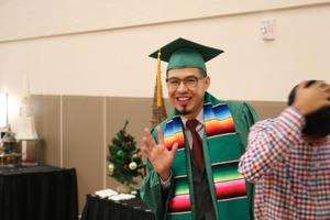 [Graduate waving at 2017 Multicultural Graduation]