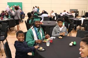 [Student and children at 2017 Multicultural Graduation 2]