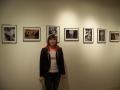 Photograph: [Student in front of photography work]