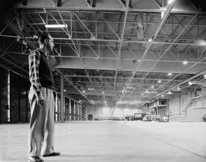 [Man standing within Braniff building]