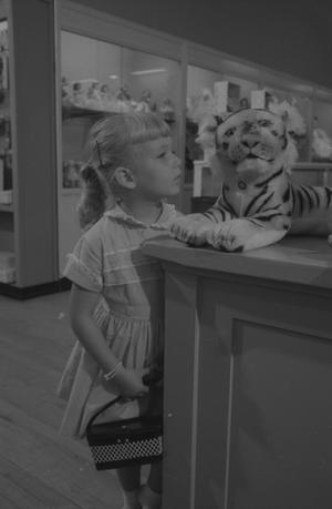 [Cheryl looking at a stuffed toy tiger, 2]