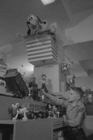 [Junebug Clark touching a robot toy, 4]