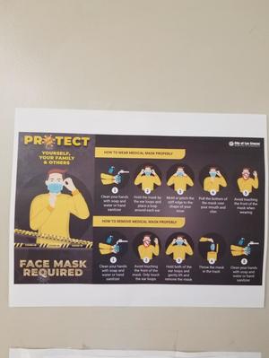 [Signage regarding face masks at Thomas Branigan Memorial Library]