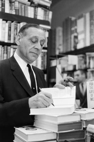 [Robert Briscoe autographing his book in a bookstore]