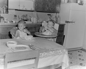 [Photograph of Byrd IV and Pam as toddlers eating cakes in highchairs]