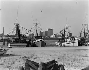 [Photograph of four boats docked]