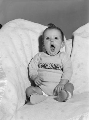 [Photograph of Pam Williams sitting on a couch as a baby]