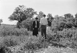 [Irene, John and Charles standing in a field]