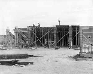 [Photograph of construction workers building the Amon G. Carter Stadium]