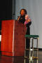 Primary view of [Cassandra Berry on stage behind a podium]