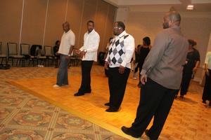 [Men lined up to dance at 2012 TABPHE conference 1]