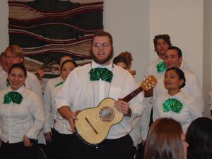 [Mariachi guitarist and singers at 15th Annual Celebración Banquet]