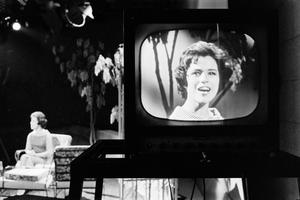 [A woman on a television screen, 2]