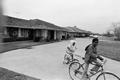 Photograph: [Angela and Dion Pride riding bicycles, 7]