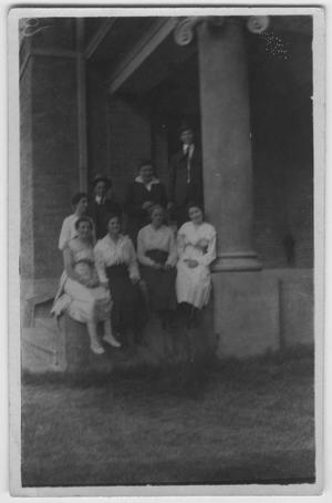 Primary view of object titled '[A group at the entrance of an administration building]'.