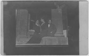 [Three women gathered in front of a building]