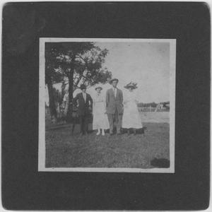 [Two men and two women standing outdoors]
