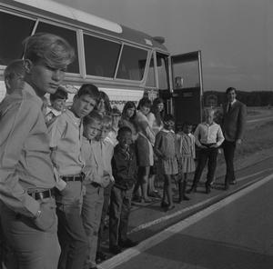 [John DeLorean, Kelly and children with a bus]